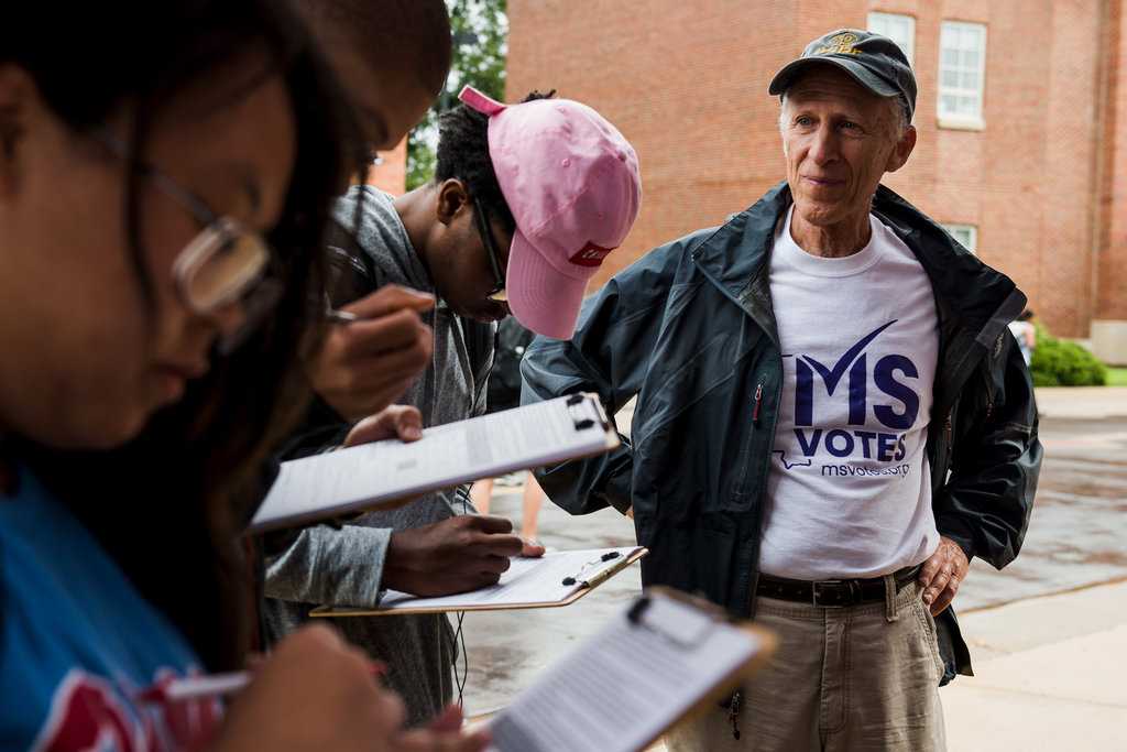 Howard Kirschenbaum, right, helped students at the University of Mississippi register to vote on Tuesday. Mr. Kirschenbaum is a veteran volunteer of the Freedom Summer 1964